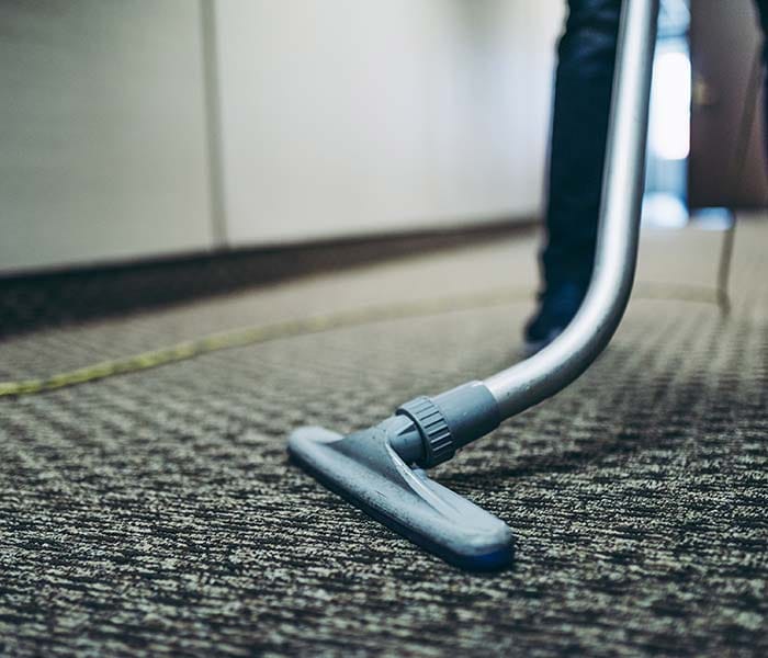 Independent cleaning professionals vacuuming and mopping floors during recurring commercial office cleaning
